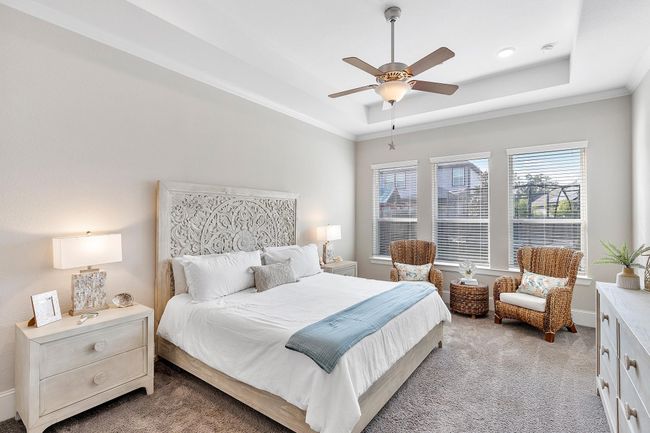 Retreat to a luxurious primary suite featuring a cozy sitting area—the perfect space to unwind, recharge, and relax in comfort. | Image 22