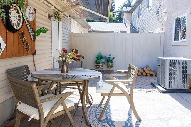 Fenced backyard with a patio and outdoor dining area | Image 25