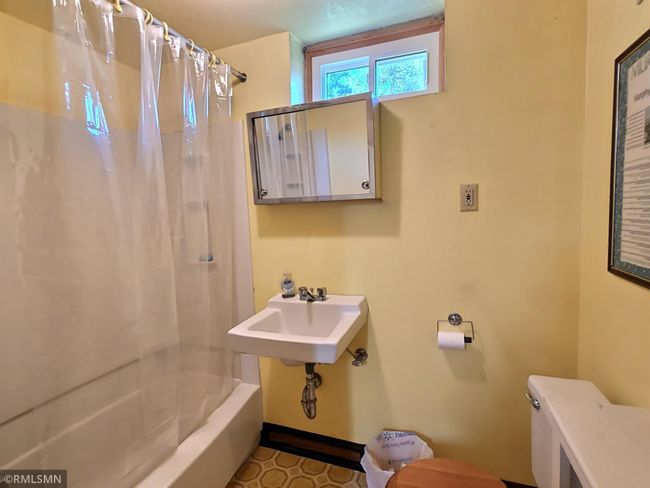 The second full bathroom is located in the lower level and is as charming as can be. Many original colors and materials make this bathroom timeless and practical. | Image 17