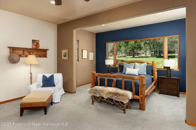 A serene and inviting space, the touch of rustic charm caps off this private primary suite. | Image 16