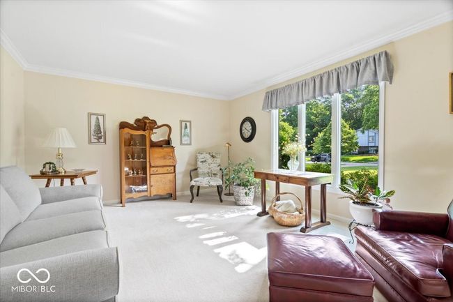 living area with ornamental molding and carpet | Image 6