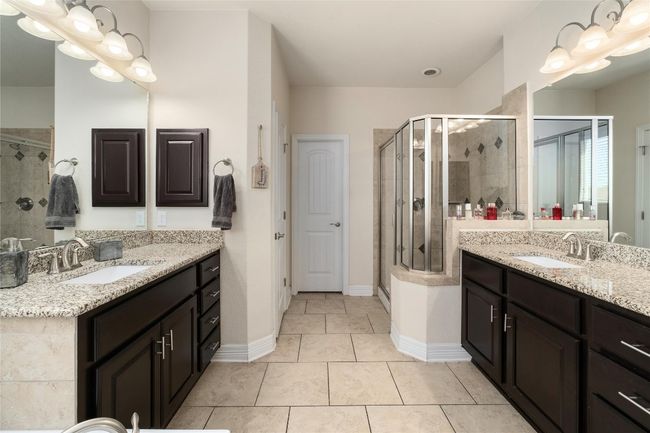 Bathroom featuring a sink, a stall shower, and tile patterned floors | Image 16
