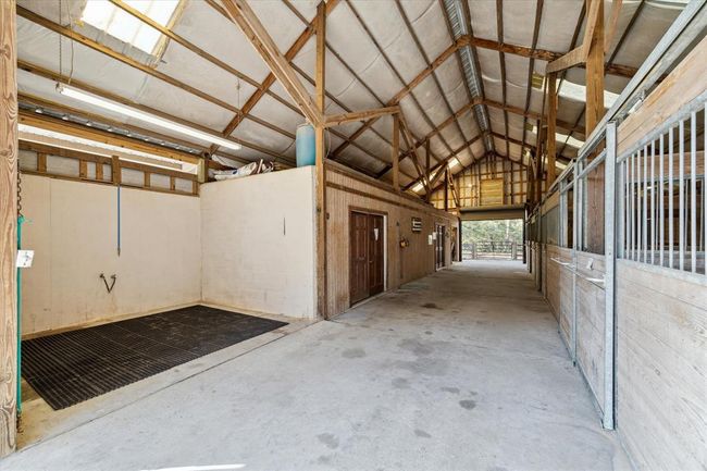 This spacious wash bay conveniently located across from the 5 stalls provides a safe and comfortable place for washing, grooming and veterinary "barn calls." The skylights provide necessary natural light. | Image 42