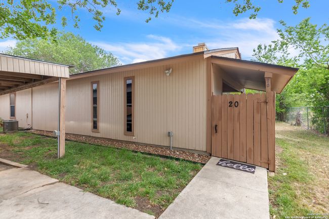Gate to the back patio next to the 2-car carport | Image 24