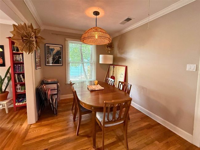 Dining space with light wood finished floors and ornamental molding | Image 6