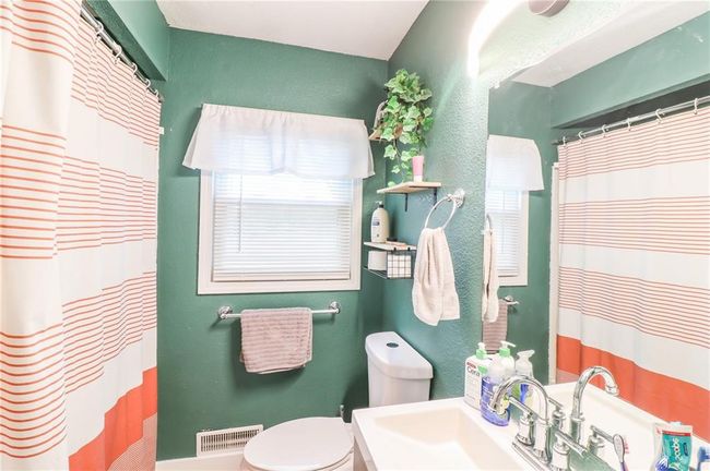 Full bath with vanity, a shower with shower curtain, and a textured wall | Image 30