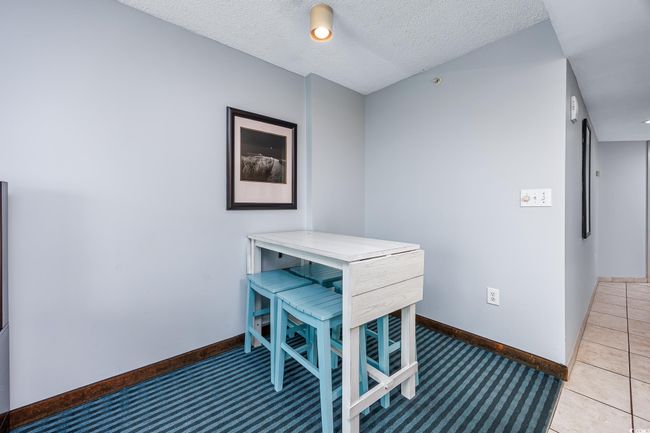 Tiled dining room with a textured ceiling and baseboards | Image 11