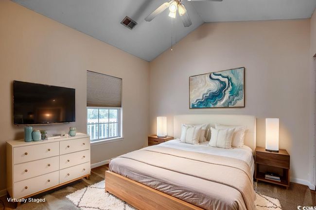 Bedroom with baseboards, visible vents, ceiling fan, and lofted ceiling | Image 5