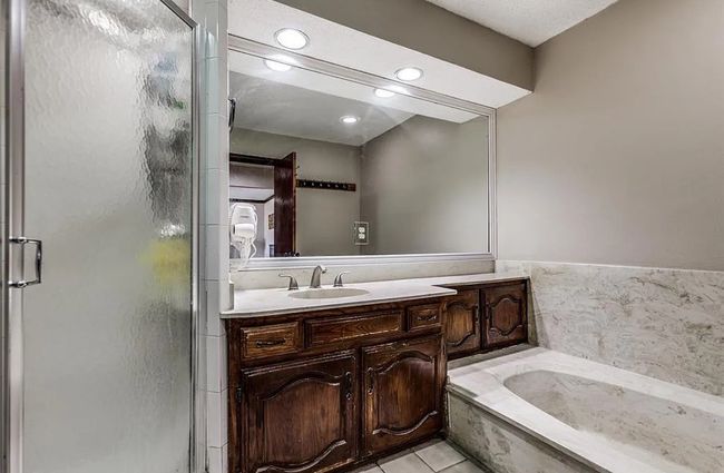 Bathroom featuring vanity, a shower stall, a garden tub, tile patterned floors, and recessed lighting | Image 10