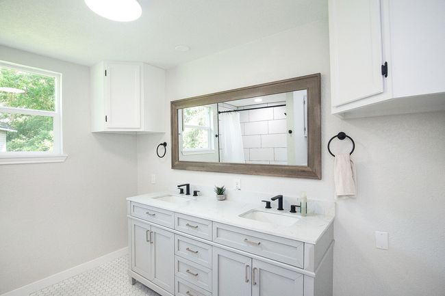 Bathroom featuring double vanity, plenty of natural light, and a shower with shower curtain | Image 19