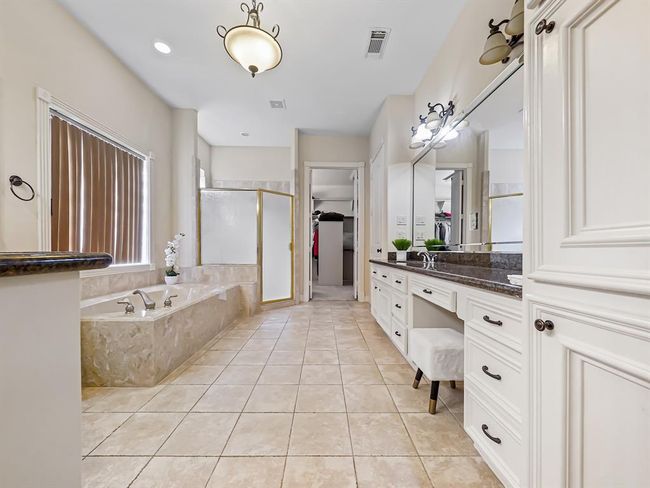 Luxurious master bathroom featuring a spacious brand new walk in shower, separate soaking tub, and elegant double sinks. | Image 26