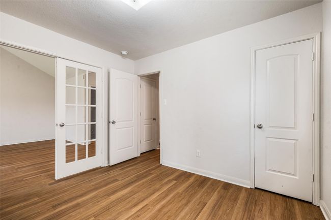 Unfurnished bedroom with wood finished floors and baseboards | Image 17