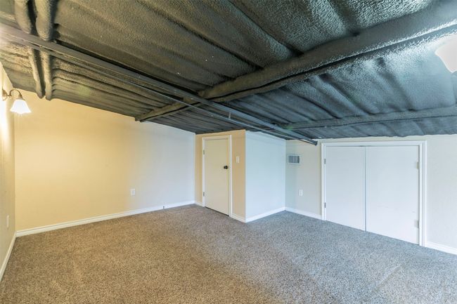 Finished below grade area featuring baseboards, visible vents, and carpet flooring | Image 19