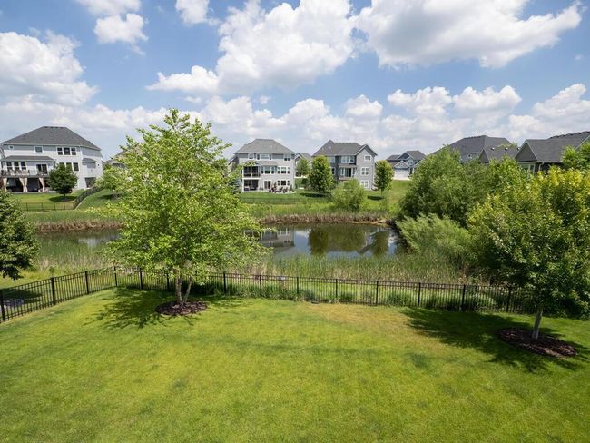 Fully fenced in backyard with a water view. | Image 30