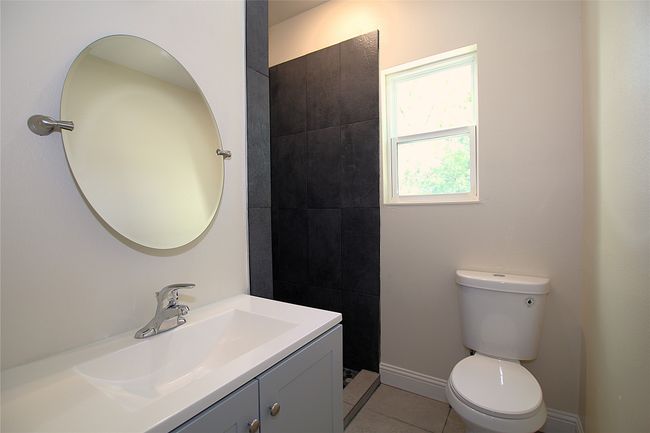Bathroom featuring toilet, vanity, tile patterned floors, and baseboards | Image 9