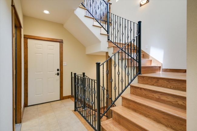 The door leads to the attached 3 car garage. The stairs up lead to the Library, stairs down to the Wine Cellar. Door to the left is the laundry room and exits to the garden and breezeway to the detached shop & 3 car garage. | Image 21