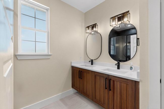 Full bathroom featuring double vanity and baseboards | Image 10