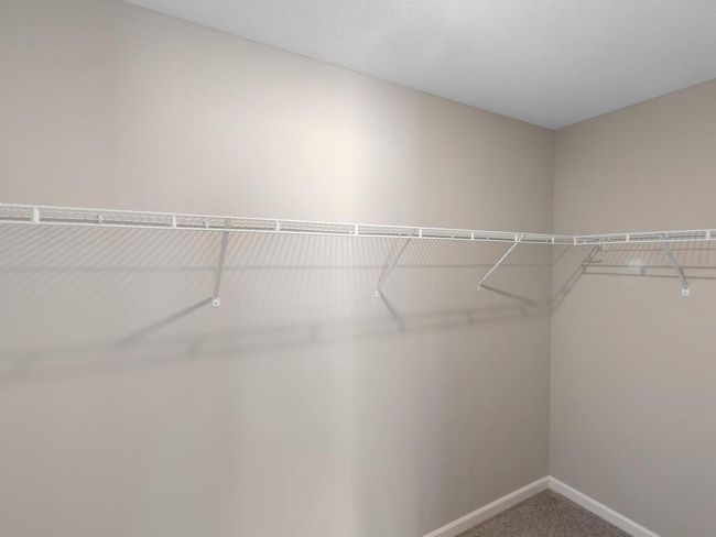 Primary Suite Walk-In Closet - Photo of similar home, finishes may vary, call list Agent with questions | Image 7