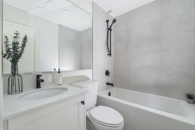 Bathroom featuring bathtub / shower combination and vanity | Image 4