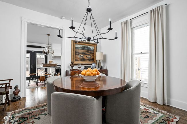 Dining space, hardwood floors, and a notable chandelier | Image 12