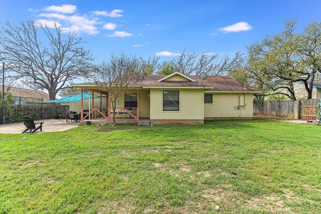 Rear view of house featuring a fenced backyard, a yard, and a patio area | Image 22