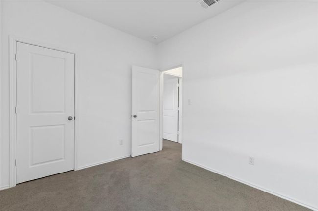 Unfurnished bedroom featuring carpet floors and baseboards | Image 13