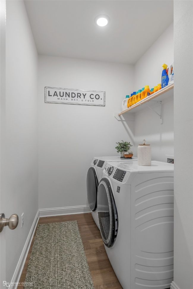 Washroom with independent washer and dryer, laundry area, baseboards, and dark wood finished floors | Image 25