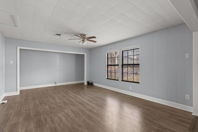 Spare room with dark wood finished floors, baseboards, and ceiling fan | Image 16