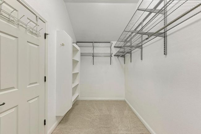 Walk in closet with light colored carpet | Image 26