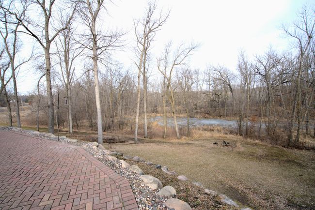 Patio looks out onto a peaceful pond | Image 19