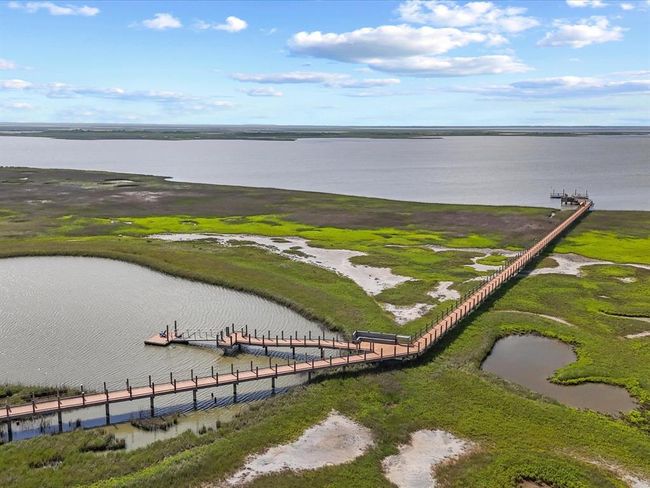 Seahorse Estates isn’t just beachfront — it’s bayfront, too. This private, lighted boardwalk leads residents directly into the Drum Bay Nature Preserve, where fishing, crabbing, and kayaking are daily rituals. It’s a rare opportunity to live where nature and luxury coexist. | Image 7
