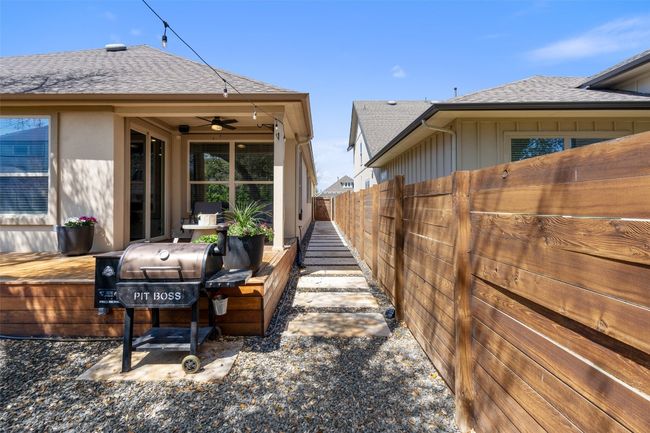 View of yard with ceiling fan and a wooden deck | Image 33