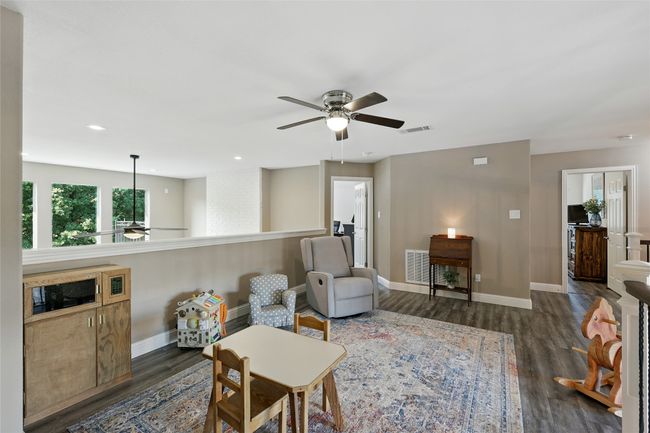 Loft game room featuring a ceiling fan, dark wood-style floors, and recessed lighting | Image 18
