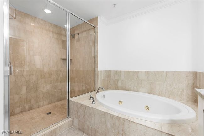 Bathroom featuring ornamental molding and independent shower and bath | Image 41
