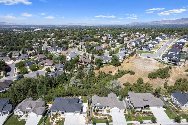 Aerial overview of property's location with nearby suburban area and a mountainous background | Image 34