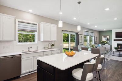 Enjoy plenty of seating at the kitchen island and dining area adjacent to the kitchen. Perfect for entertaining or having a family meal together. (Model photo) | Image 3