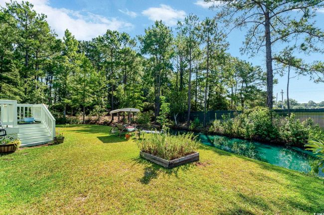 View of yard with a deck with water view | Image 23