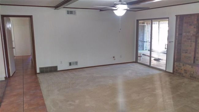 Spare room featuring a ceiling fan, baseboards, beam ceiling, and tile patterned floors | Image 4