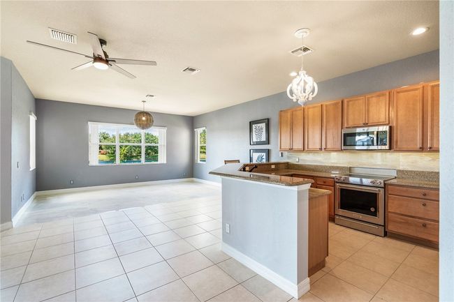 Kitchen and Great Room Opens to Covered Patio with Lake Views. | Image 6