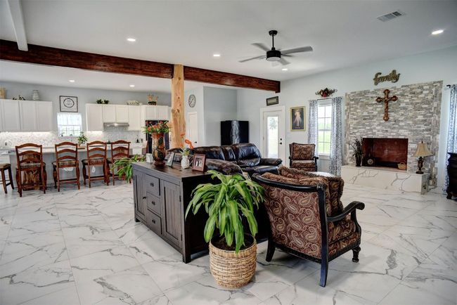 Another view of the large living area and kitchen section in the background | Image 13
