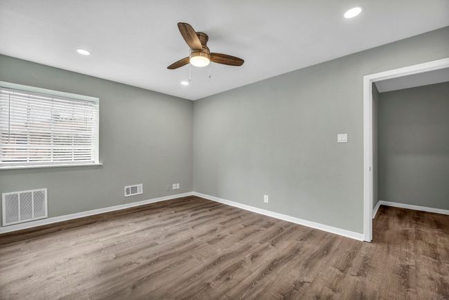 Spare room with ceiling fan, baseboards, wood finished floors, and recessed lighting | Image 11