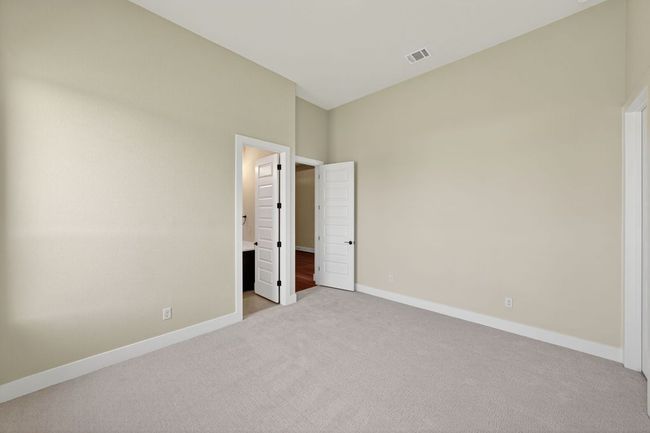 Unfurnished bedroom featuring carpet and ensuite bathroom | Image 26