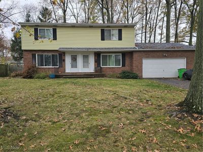 Front of property featuring a front lawn and a garage | Image 1