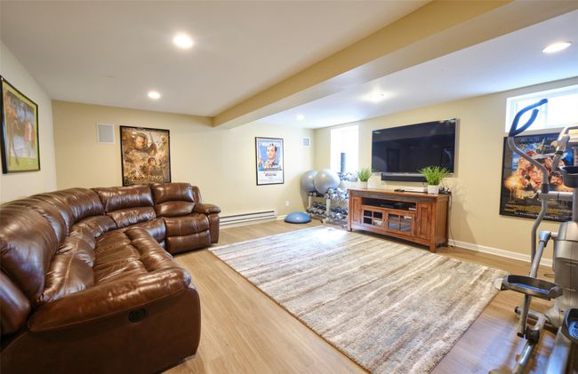 Living room featuring recessed lighting, baseboard heating, baseboards, and wood finished floors | Image 26