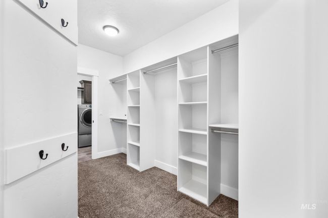 Walk in closet with carpet flooring and washer / clothes dryer | Image 19
