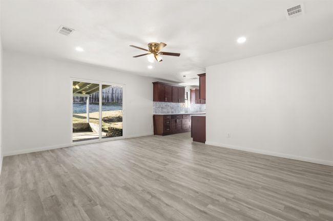 Unfurnished living room featuring ceiling fan and light hardwood / wood-style flooring | Image 8