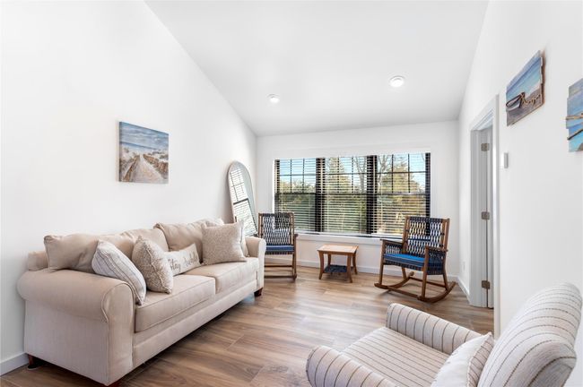 Living room with vaulted ceiling, recessed lighting, wood finished floors, and baseboards | Image 8