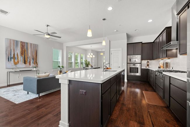 Generous cabinet space and a walk-in pantry keep everything organized and within reach, ensuring your kitchen is always ready for your next meal | Image 15
