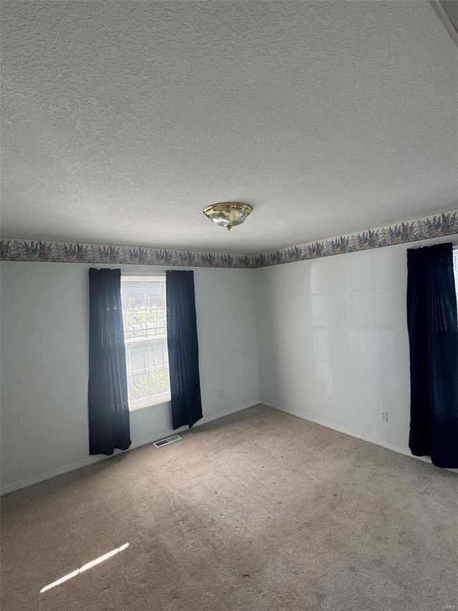 Carpeted spare room with a textured ceiling | Image 11
