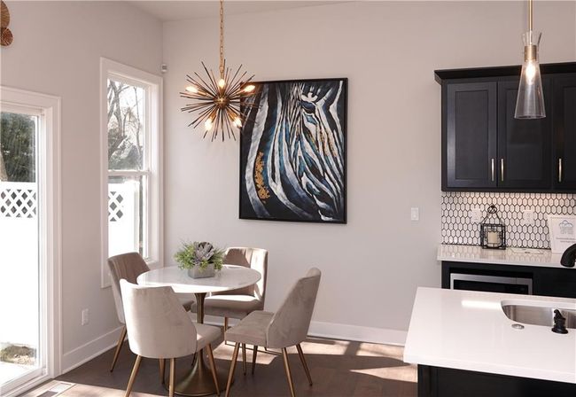 Dining room featuring dark wood finished floors, baseboards, and an inviting chandelier | Image 14